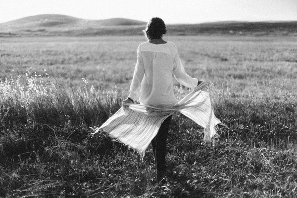 Woman in nature discovering her path to self-healing and self-improvement finding inspiration in her surroundings